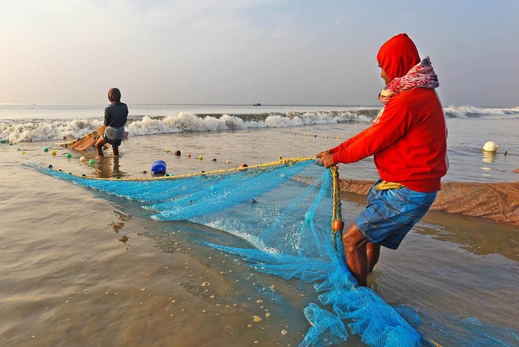 a man holding a net in the water