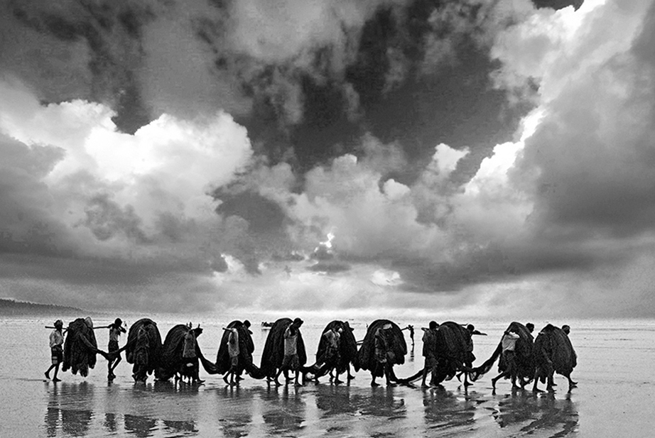 a group of people walking on a beach