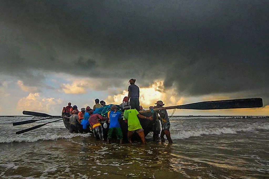 a group of people on a boat in the water