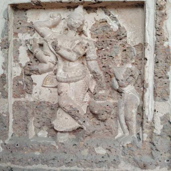 a stone carving of a man and a woman