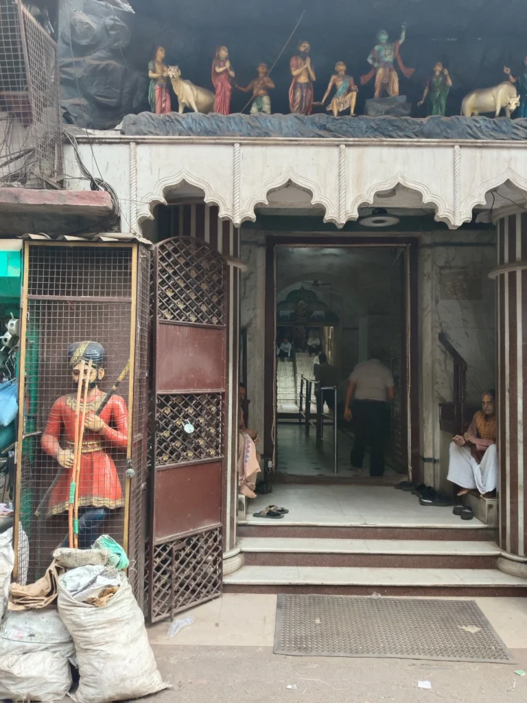 Marwari shrine amidst bustling marketplace.
